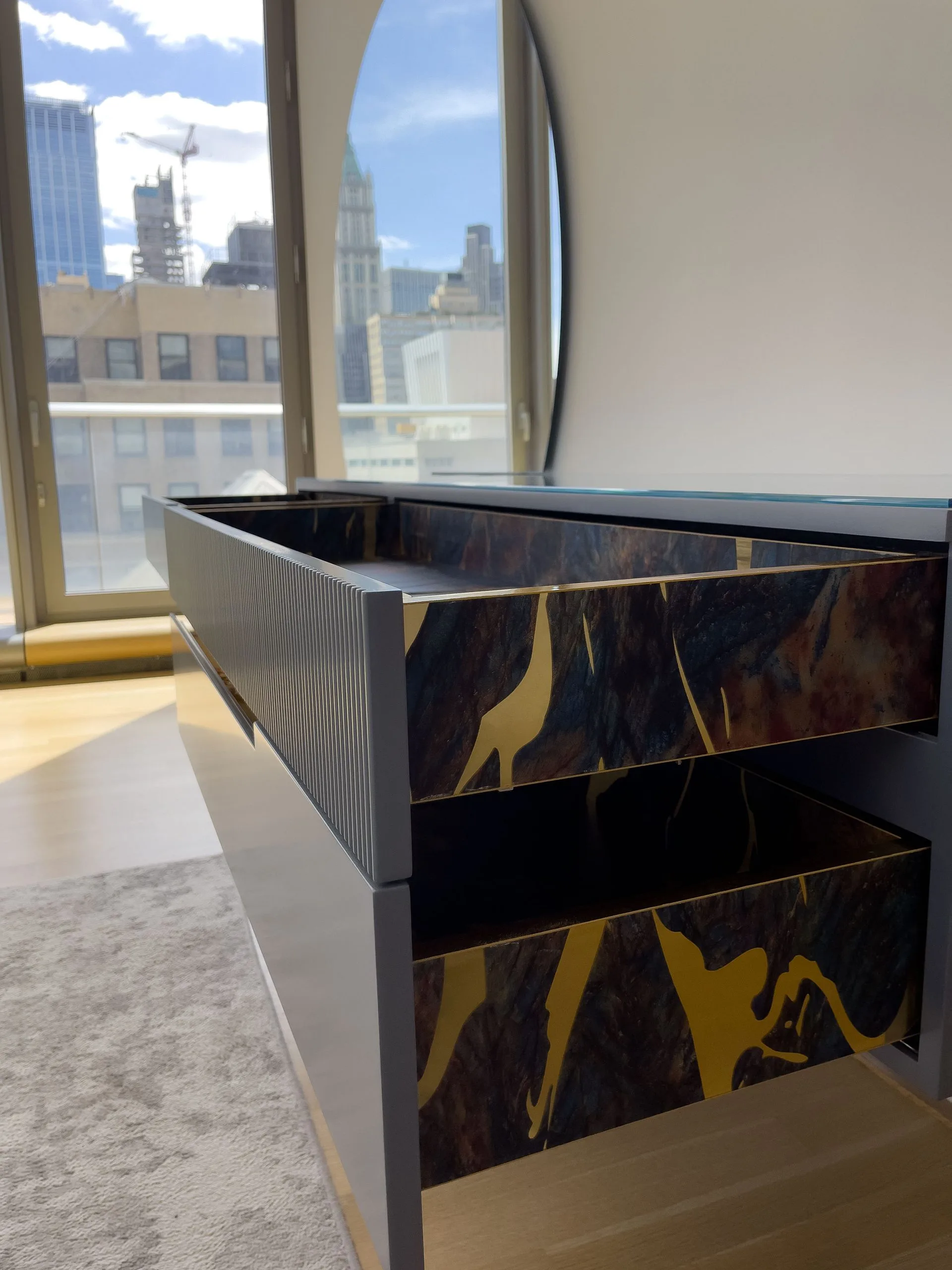 HER console with both drawers open, Lower Manhattan skyline behind