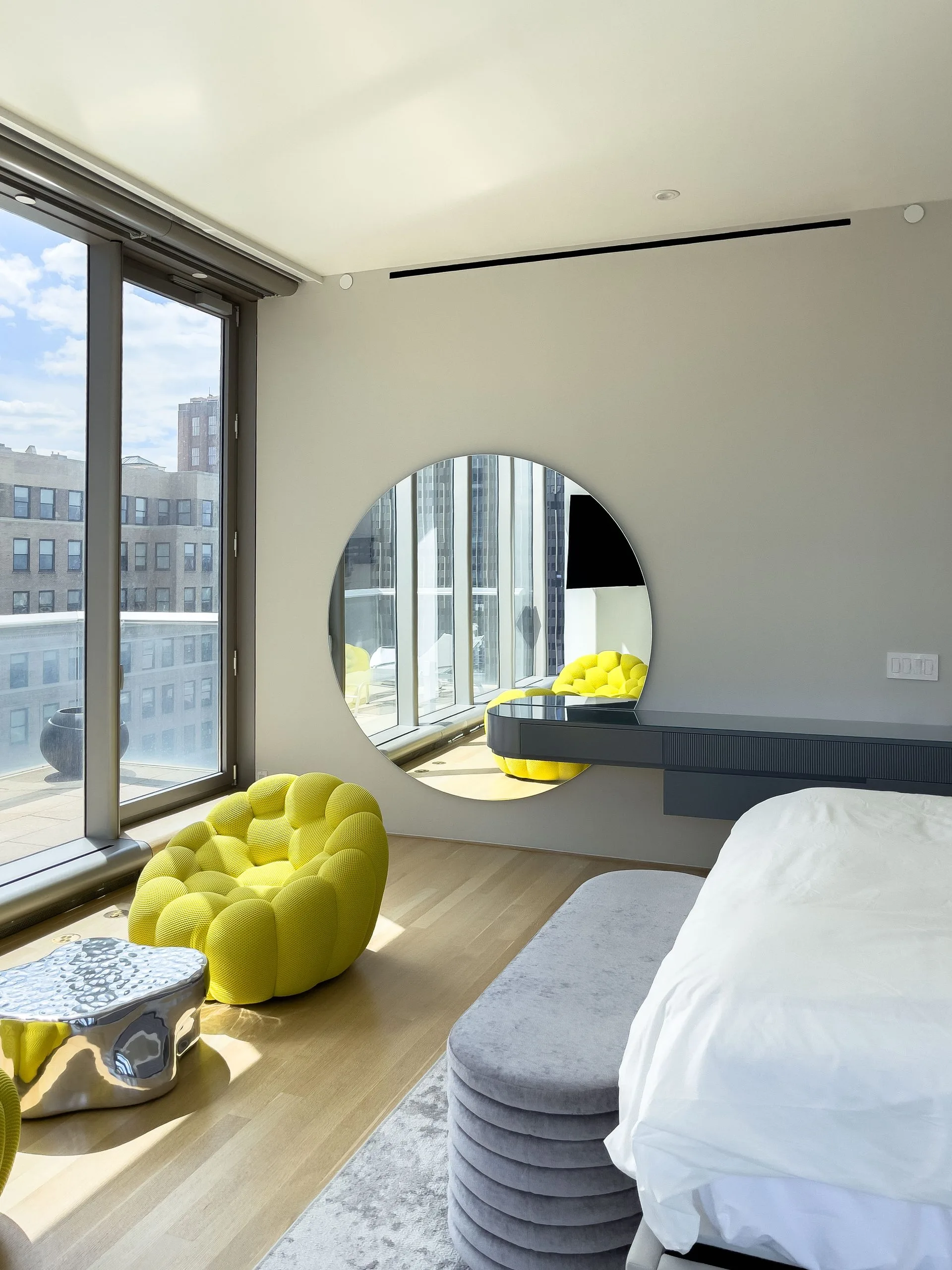 Floating dressing console and round mirror by Wewillbebirds in a Tribeca bedroom, New York City