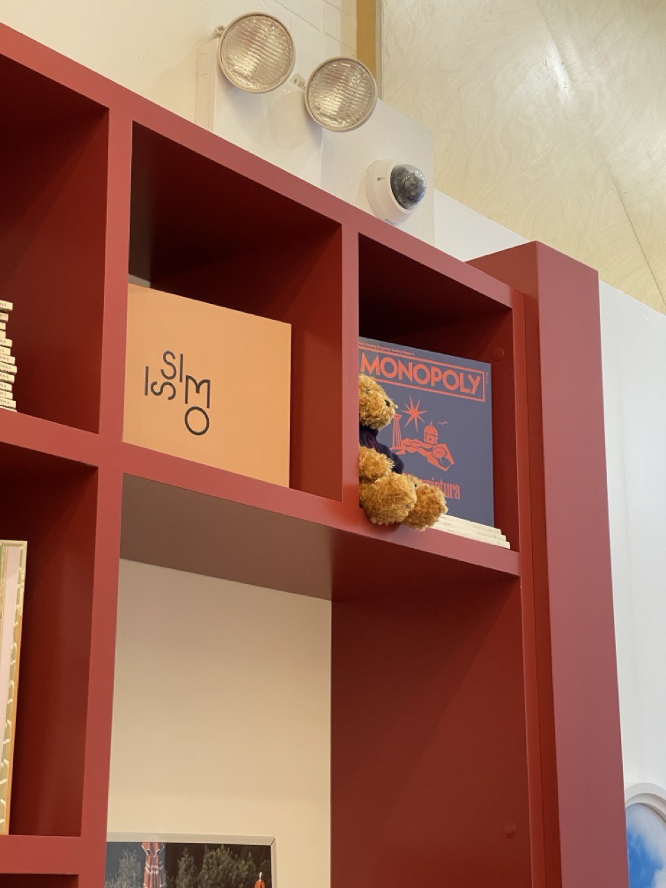 Open cubby niche in terracotta millwork with a card and a small plated display
