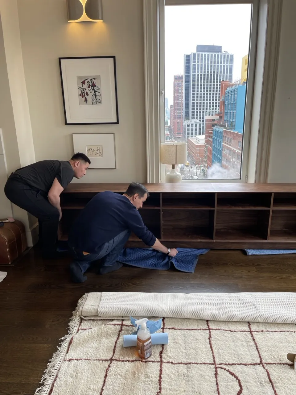 Two craftsmen installing the credenza