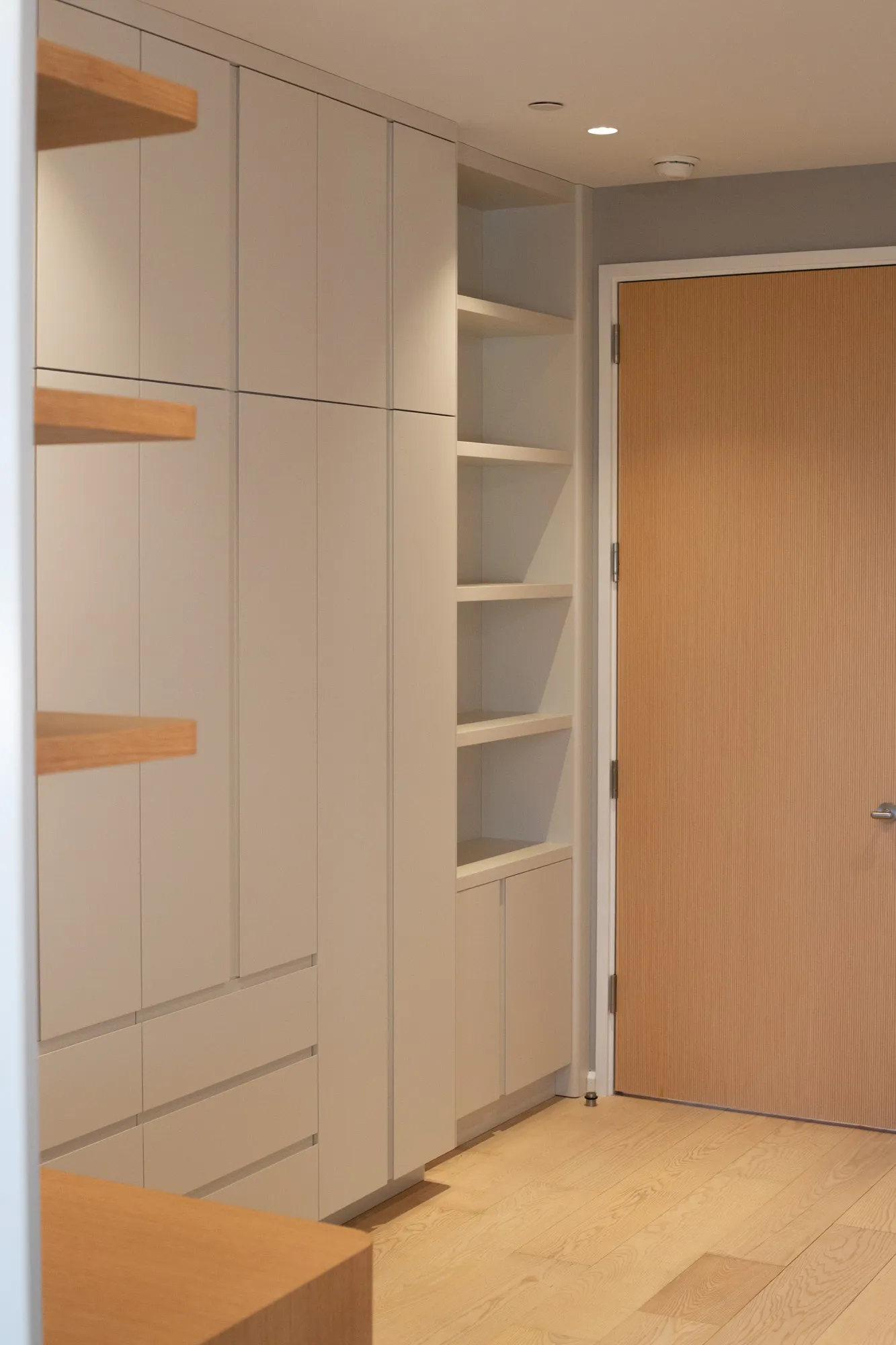 The built-in from the apartment beyond — closed wall, all seams visible