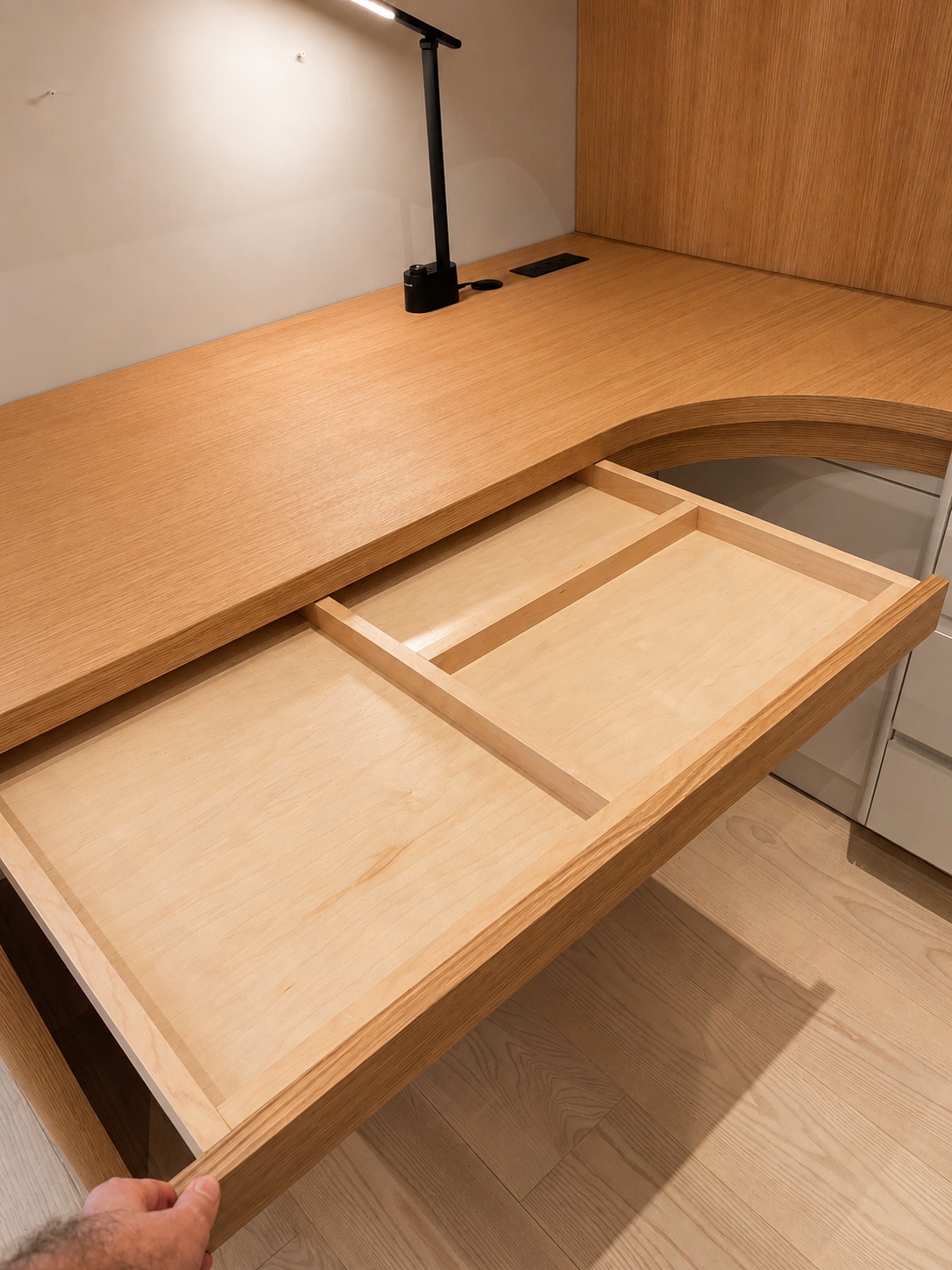 The desk drawer pulled out — maple sides, dovetailed corners, maple bottom, single divider