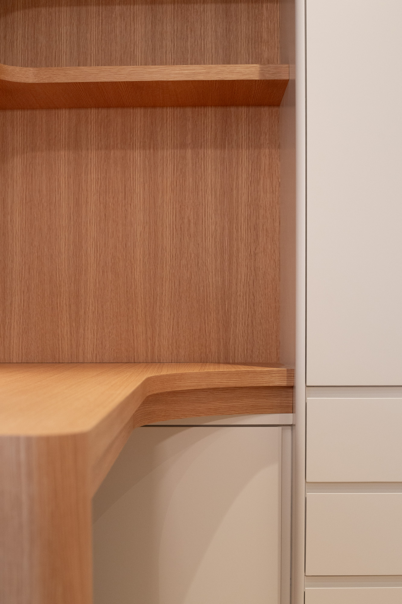 Oak shelves above the desk corner